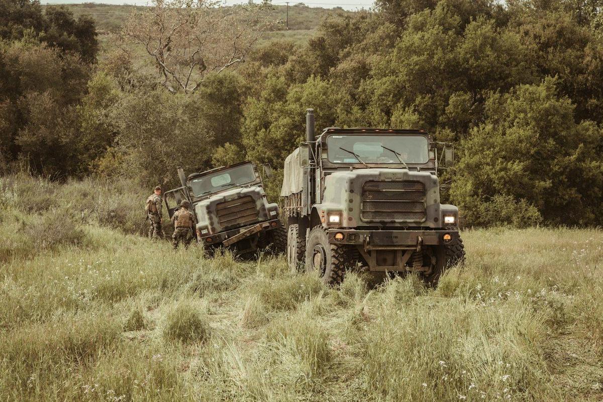 Military tactical trucks operating in field terrain