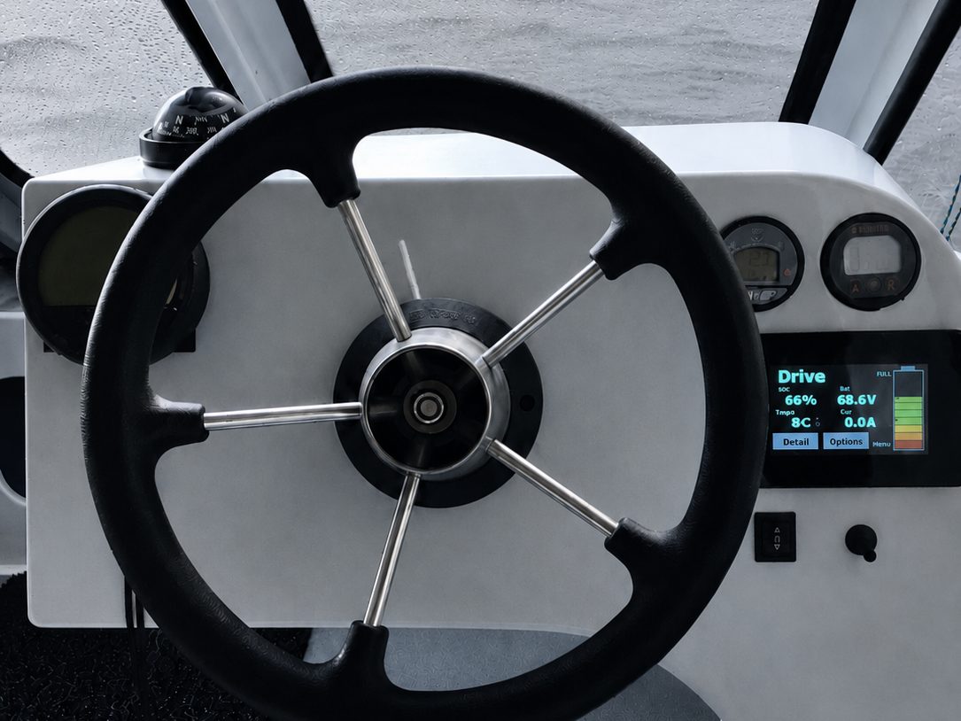 Boat helm with a Vero display showing live drive mode, state of charge, and pack voltage