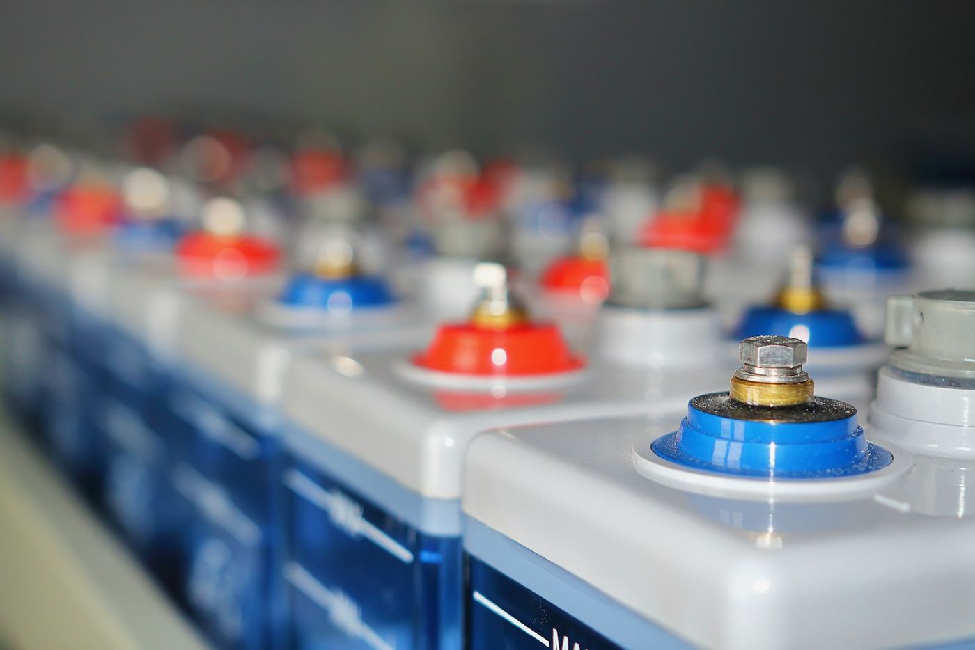 Rows of stationary storage battery cells in a battery room